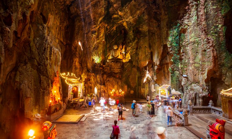 Indian tourists at Marble Mountains wearing dress-code-compliant clothing with closed-toe shoes for Linh Ung Pagoda