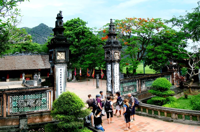 Indian tourists in salwar kameez and full-sleeve attire visiting Hoa Lu Ancient Capital temples observing dress code
