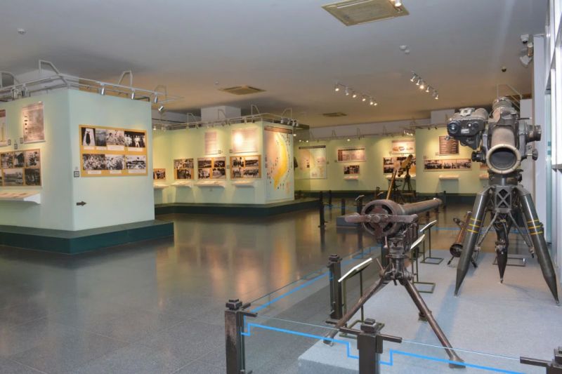 War Remnants Museum outdoor courtyard displaying captured US military M48 Patton tank and UH-1 Huey helicopter