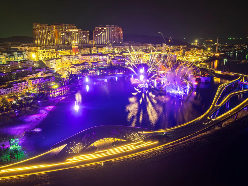 Kiss Bridge's LED lights reflected on the water at night in Phu Quoc