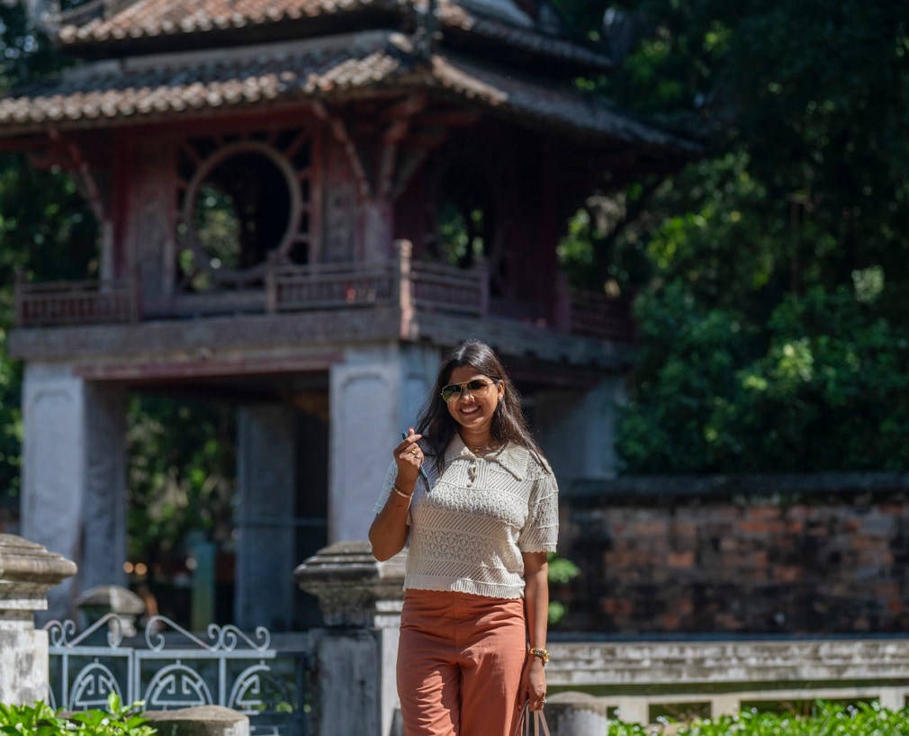 Roshni from New Delhi, poses for a souvenir photo in Temple of Literature, Hanoi