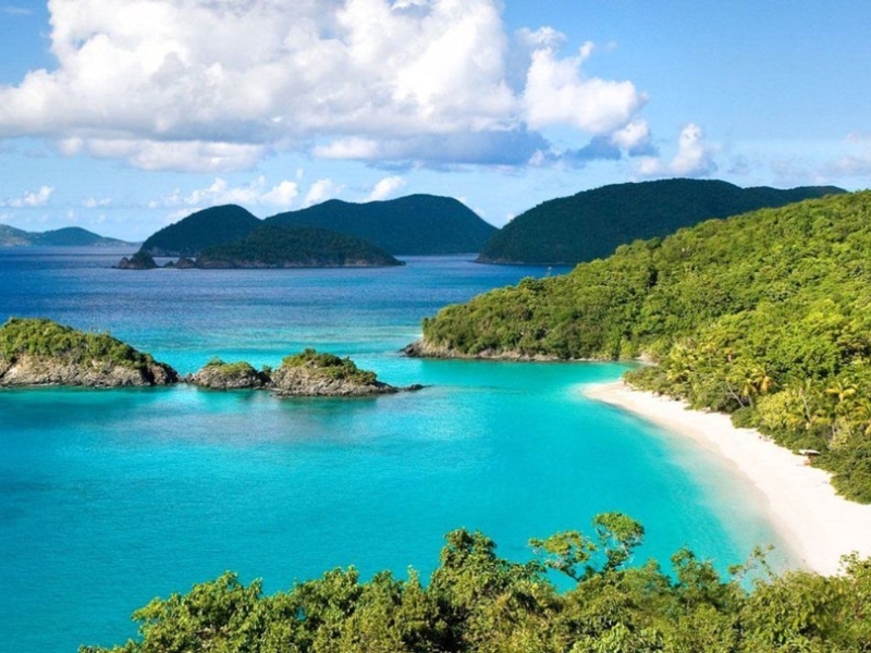 The stretch of fine white sandy beach is long under the shining sun's light