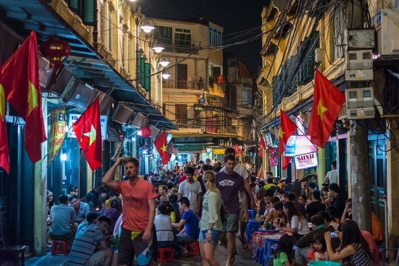 People gather and drink beer at Ta Hien Street at night