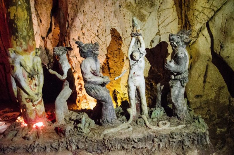 Am Phu Cave 18 levels of Buddhist hell stone sculptures depicting Thap Bat Dia Nguc karmic punishments inside Thuy Son mountain