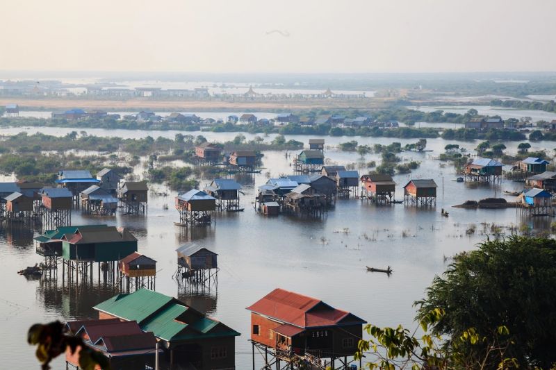 August in Cambodia — Tonle Sap Lake floating village at peak water level during heavy monsoon