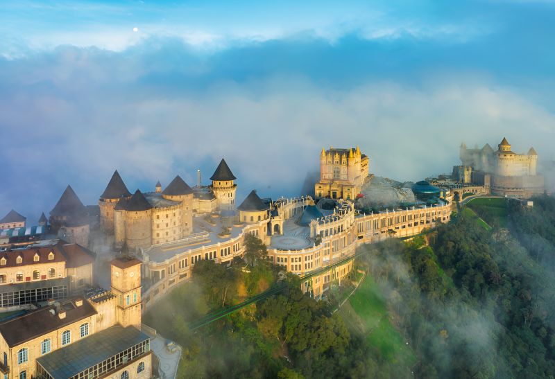 Ba Na Hills weather and temperature with morning fog rolling through French Village rooftops