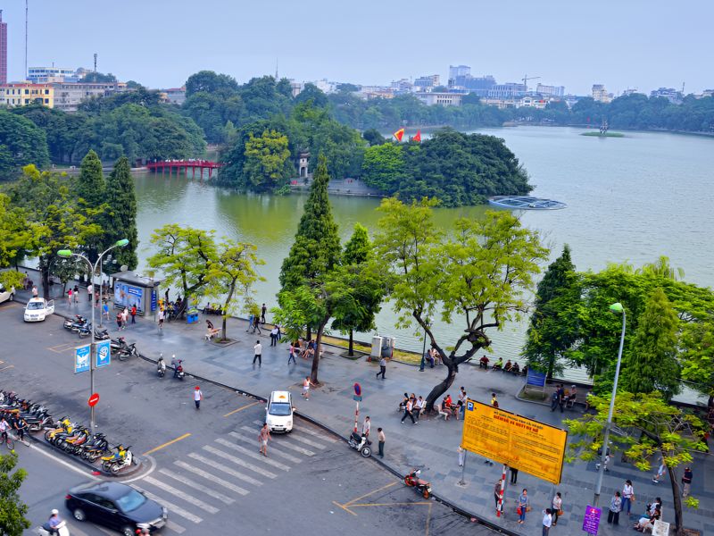 Best time to visit Hanoi Walking Street during late autumn evening with clear weather mild temperatures and active pedestrian crowd