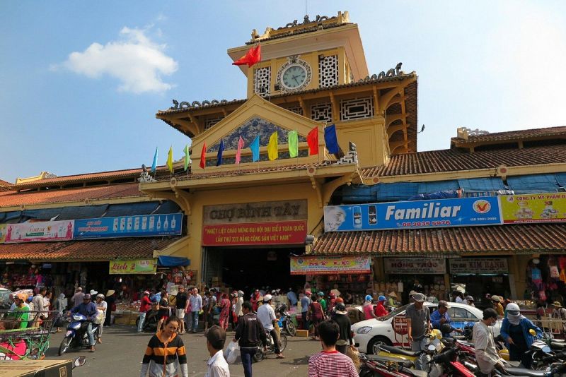 Binh Tay Market opening hours entrance with market signage showing Cho Binh Tay name and operating schedule
