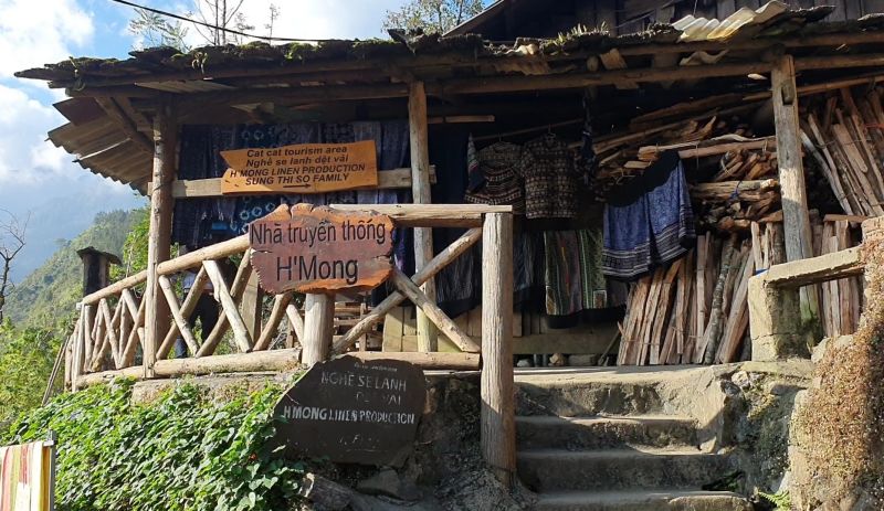Traditional Black Hmong wooden stilt house homestay at Cat Cat Village with handwoven blankets on platform beds for Indian tourists overnight stay