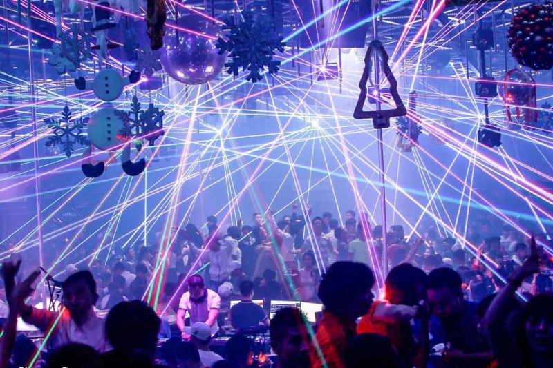 Da Nang nightclub dance floor with EDM lighting and dancers after midnight