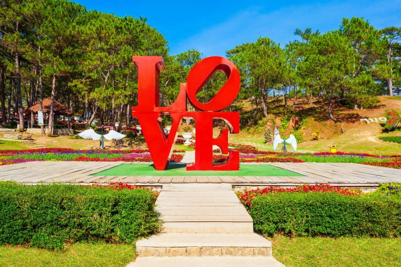 Dalat Valley of Love main entrance and ticket counter with adult entry sign during morning opening hours