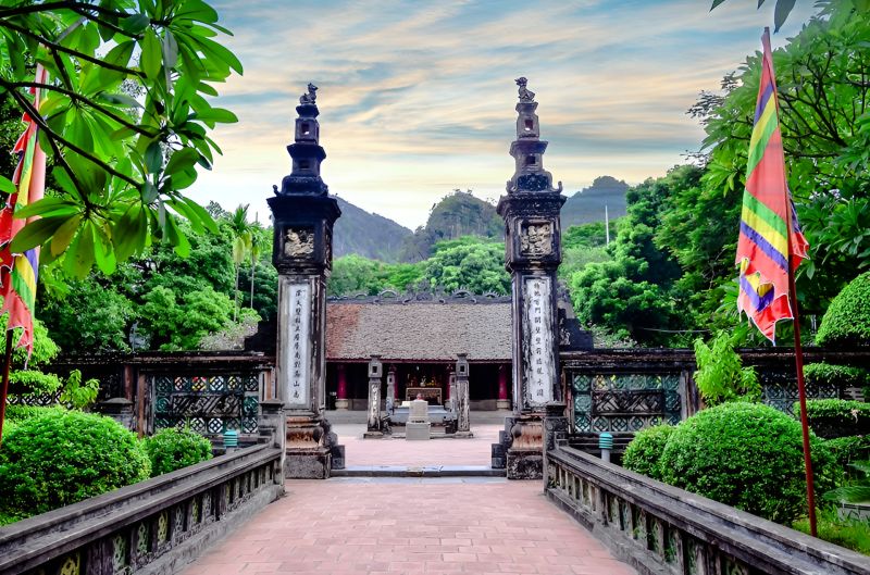 Dinh Tien Hoang Temple at Hoa Lu Ancient Capital with dragon stone staircase, yellow-glazed roof tiles, and 17th-century 3-hall layout