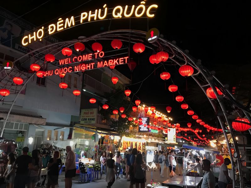 Duong Dong Night Market filled with evening visitors browsing food stalls during peak business hours