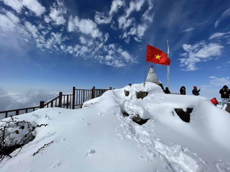 Fansipan Mountain summit in winter with frost on the 3143m pillar and snow dusting on rocks during December to February sub-zero conditions