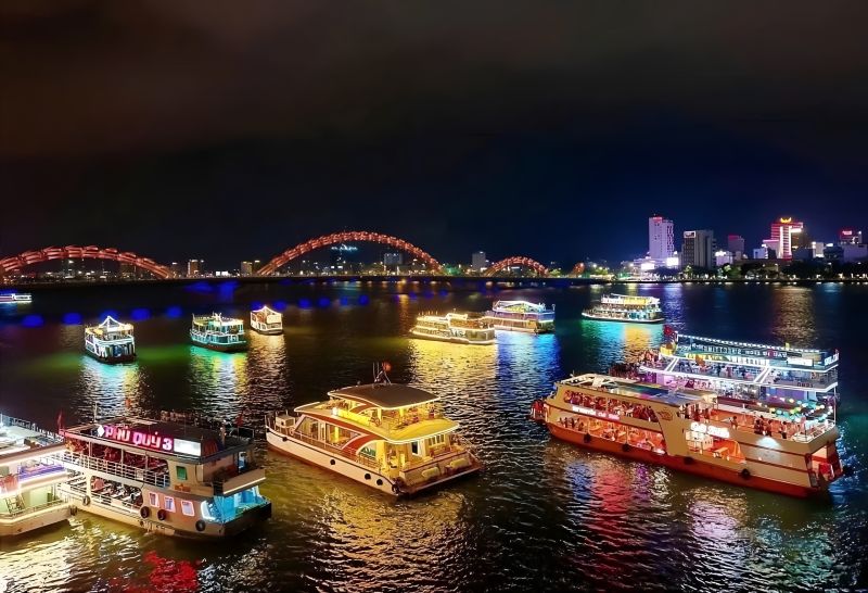 Han River cruise Da Nang showing Dragon Bridge full 666 metre length from a tourist boat at sunset before the 9 PM fire show