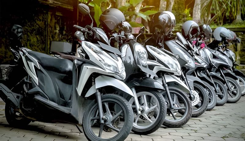 Row of Honda scooters with helmets available for rental in Hanoi for the National Highway 1A ride to Ninh Binh