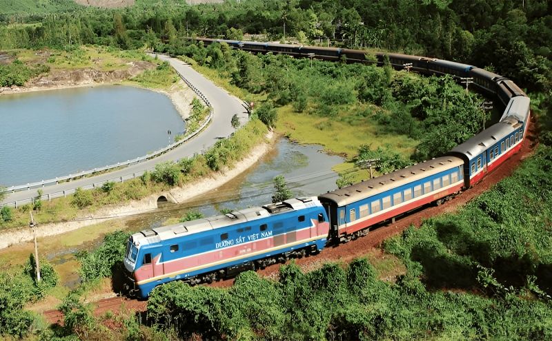 Vietnam Railways Reunification Express train passing through green countryside on the Hanoi to Ninh Binh rail route