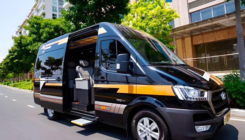 Black Hyundai Solati limousine van with sliding door open and retractable step deployed parked on an urban street