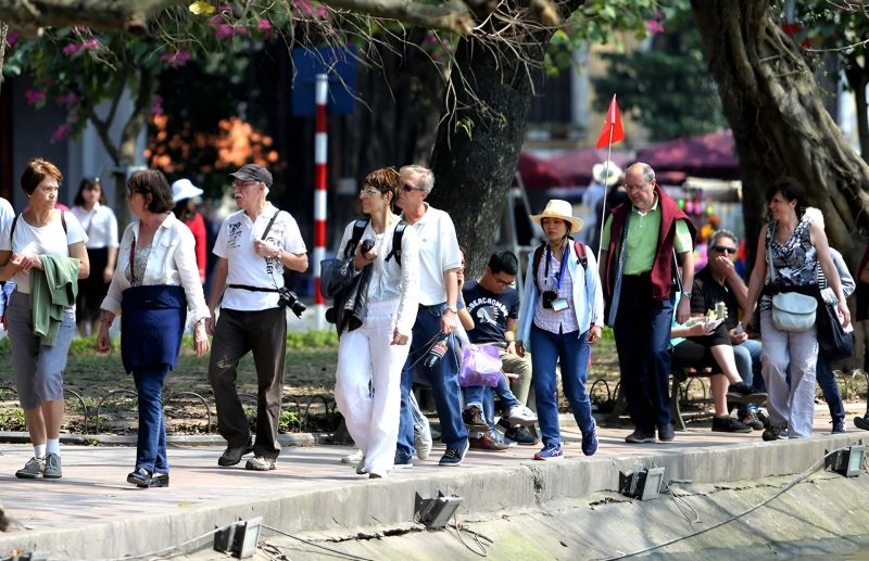 Hanoi Walking Street safety scene showing dense weekend foot traffic with families couples and tourists across the lit pedestrian zone