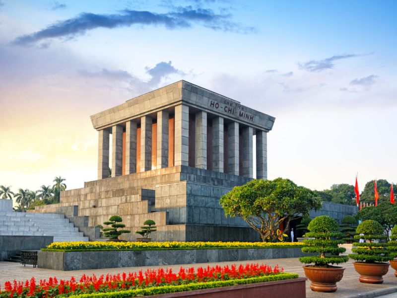 Ho Chi Minh Mausoleum granite building on Ba Dinh Square in Hanoi with honour guards and visitors queueing in two parallel lines