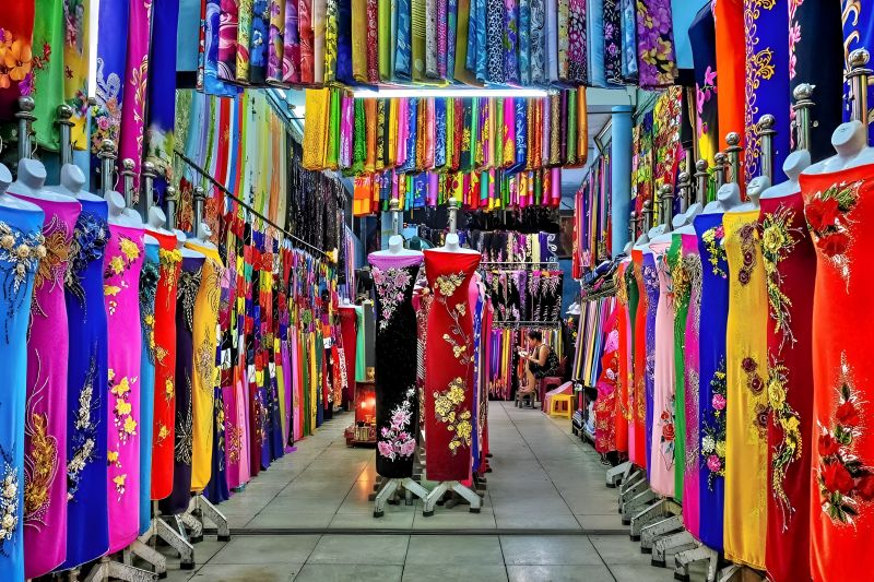 Binh Thanh District residential tailoring shop with sewing machines and silk fabric rolls for custom ao dai