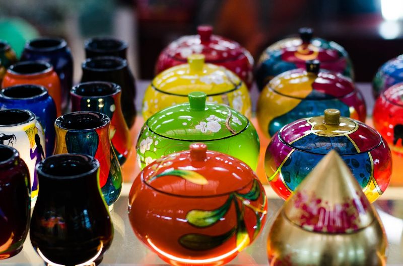 Vietnamese lacquerware bowls and trays in red and black with hand-painted patterns at Ben Thanh Market