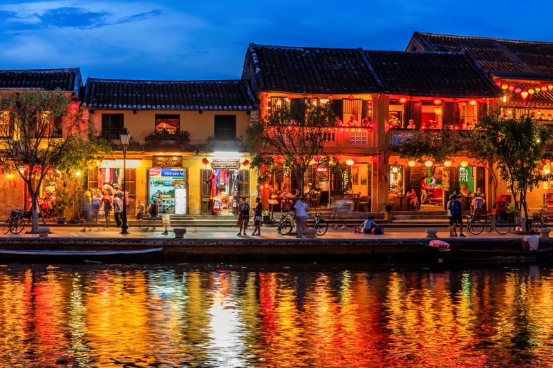 Floating paper lanterns on the Hoai River at Hoi An Night Market with UNESCO Old Town backdrop