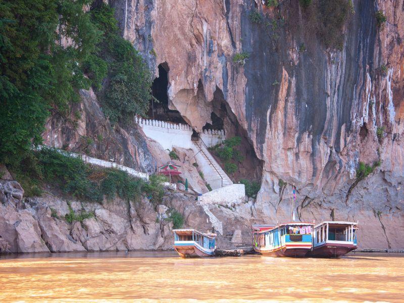 Laos rainy season May to October with lush green rice terraces and monsoon clouds, off-peak window for Indian budget travel