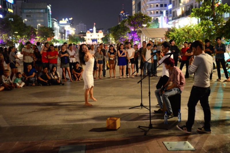 Nguyen Hue Walking Street at night with illuminated Love Fountain colour displays and LED lighting along central promenade