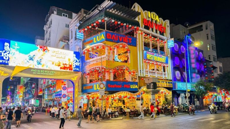Comparison between Nguyen Hue Walking Street family-friendly pedestrian boulevard and Bui Vien Street backpacker nightlife area
