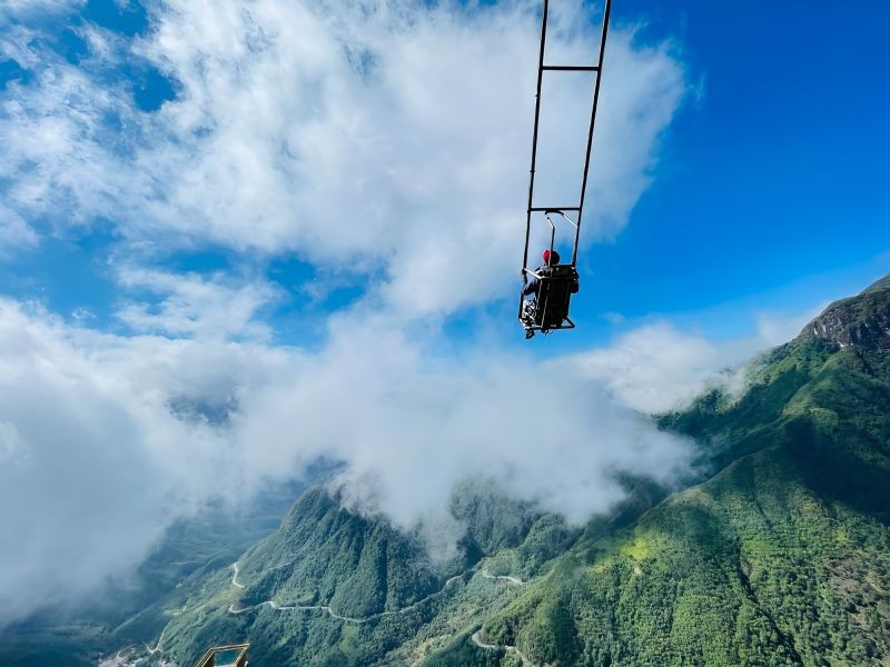 Rong May Glass Bridge Death Swing aerial swing launched from cliff face over O Quy Ho Pass valley
