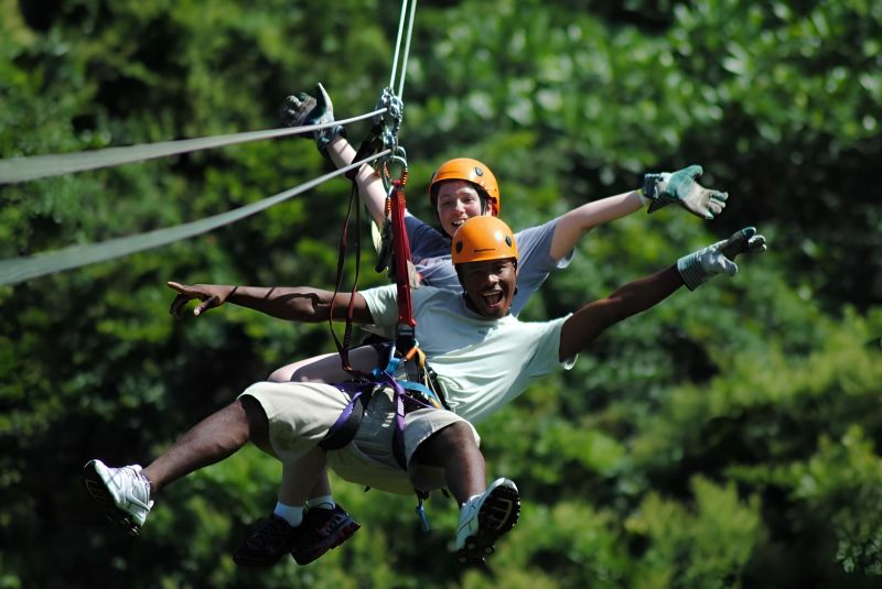 Rong May Glass Bridge zipline rider crossing O Quy Ho Pass valley on 3-cable system at 40 km/h