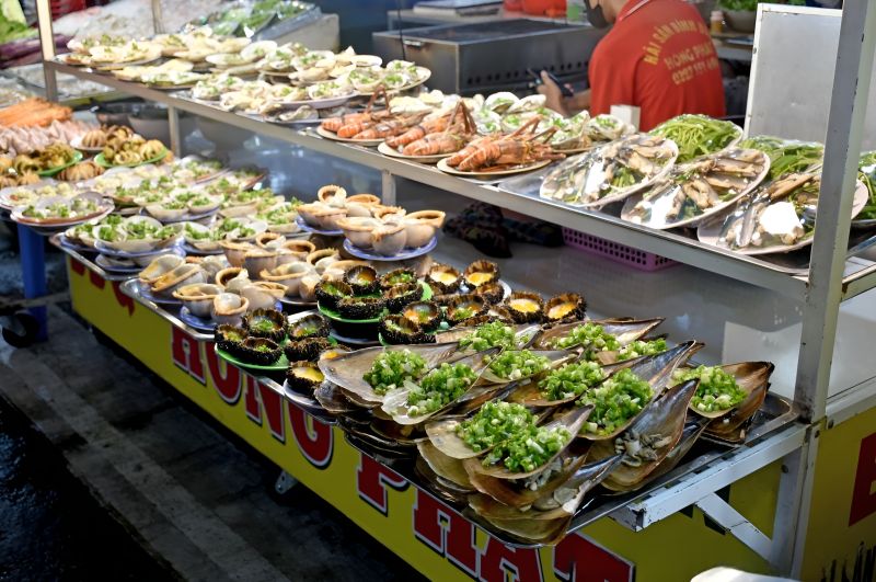 Fresh seafood display at Phu Quoc Night Market with crabs and shellfish priced per 100 grams