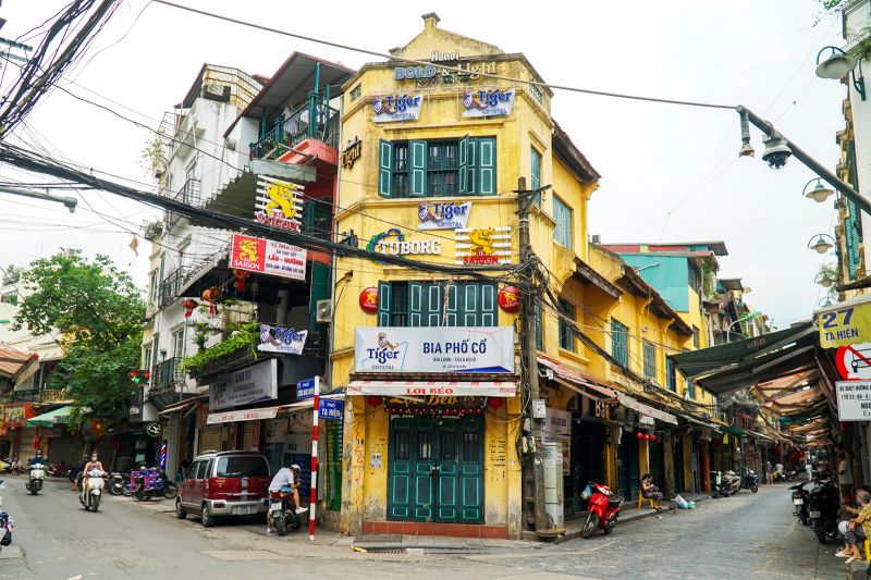 Ta Hien Street at night in Hanoi Old Quarter showing bia hoi stalls and crowded open-air seating