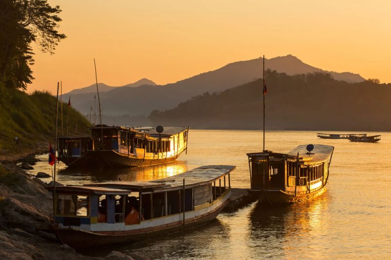 Mekong River sunset view from Don Det island in Si Phan Don 4000 Islands southern Laos with golden sky reflected on the water
