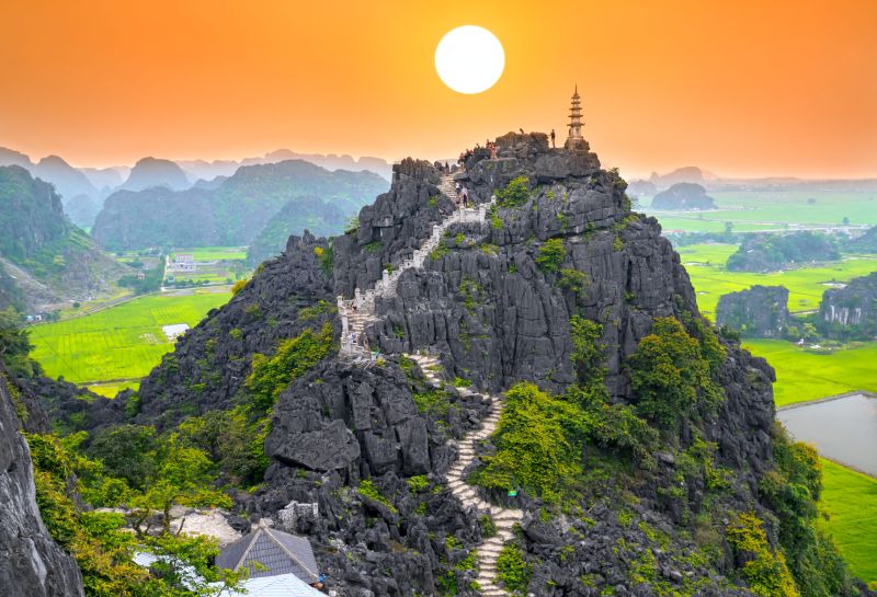 Mua Cave hike viewpoint in Ninh Binh showing the dragon staircase and panoramic view of Tam Coc valley karst peaks