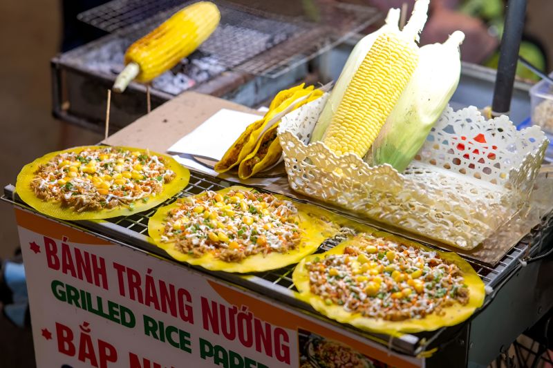 Vegetarian street food options at Phu Quoc Night Market including grilled rice paper bánh tráng nướng and fresh fruit