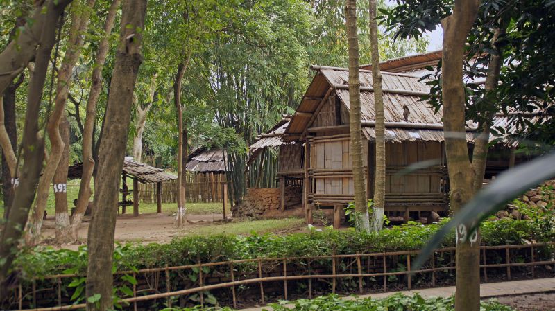 Outdoor Traditional House Garden at the Vietnam Museum of Ethnology in Hanoi showing a Bahnar communal house with 15-metre conical thatched roof